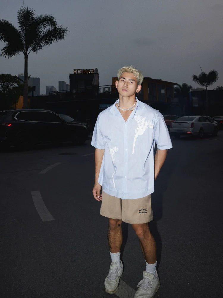 Light Blue Short-Sleeve Button-Up Shirt with White Floral Print